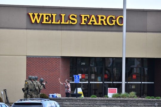 The first female hostage comes out of the Wells Fargo bank building where she had been held for hours, St. Cloud police said.