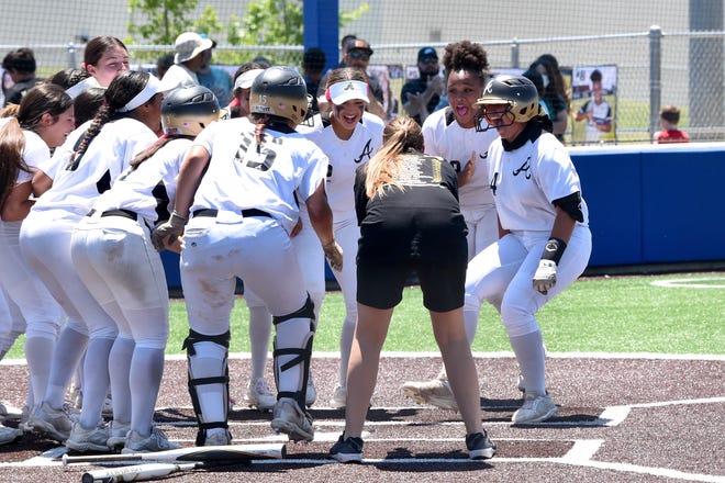 Abilene High’s Bre Barajas (4) is met by teammates at home plate after hitting a two-run home run against Euless Trinity in the one-game area playoff May 7 at Weatherford. The Lady Eagles won 4-2 to advance to the Region I-6A quarterfinals. Barajas is one of eight starters and 11 players overall returning to this year's team.