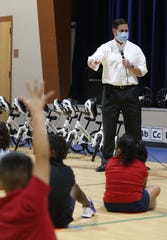 Gov. Doug Ducey answers questions from the young children during an All Kids Bike event at Scales Technology Academy in Tempe on May 6, 2021.