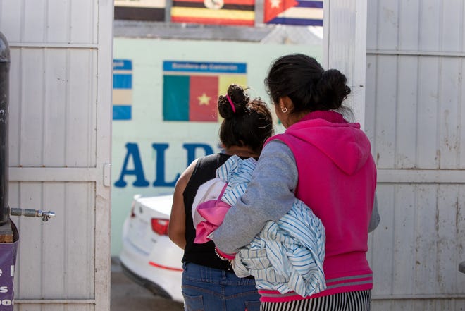 Carmela, left, and another resident of the shelter leave the courtyard to run an errand. Juan Fierro, the director of the shelter, said that he normally advises indigenous migrants to go out only with trusted companions who speak Spanish to reduce their risk of being taken advantage of or targeted for crime. (Corrie Boudreaux/El Paso Matters)