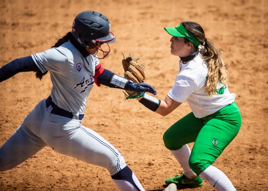 University of Arizona's Dejah Mulipola (8) sprints to first base where University of Oregon (28) Shaye Bowden waits for the ball that sends Mulipola back to the dugout at Jane Sanders Stadium on Sunday, May 9, 2021.
