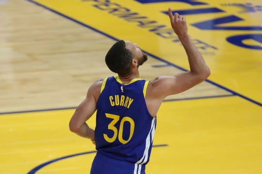 Golden State Warriors' Stephen Curry points to the sky after scoring against the Oklahoma City Thunder during the first half of an NBA basketball game in San Francisco, Saturday, May 8, 2021. (AP Photo/Jed Jacobsohn)