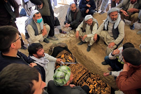 Afghan men bury a victim of deadly bombings on May 8 near a school, at a cemetery west of Kabul, Afghanistan, on May 9, 2021. The Interior Ministry said Sunday the death toll in the horrific bombing at the entrance to a girls' school in the Afghan capital has soared to some 50 people, many of them pupils between 11 and 15 years old, and the number of wounded in Saturday's attack has also climbed to more than 100.