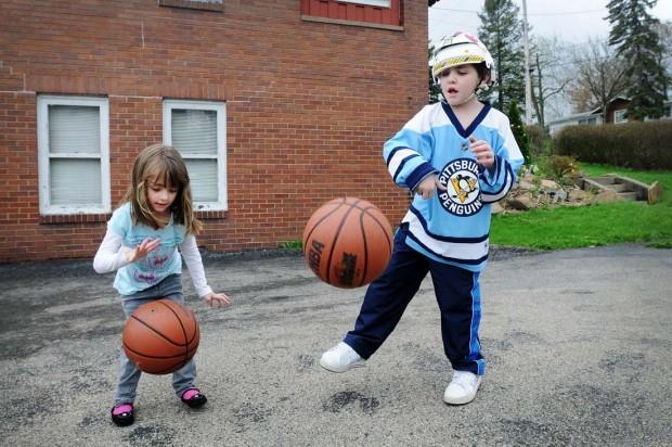 Antonio plays with his sister, Mia, in the family’s driveway in 2011. Though his right side is still weaker than his left, his strength and balance have greatly improved. {Sally Maxson/For BCY}