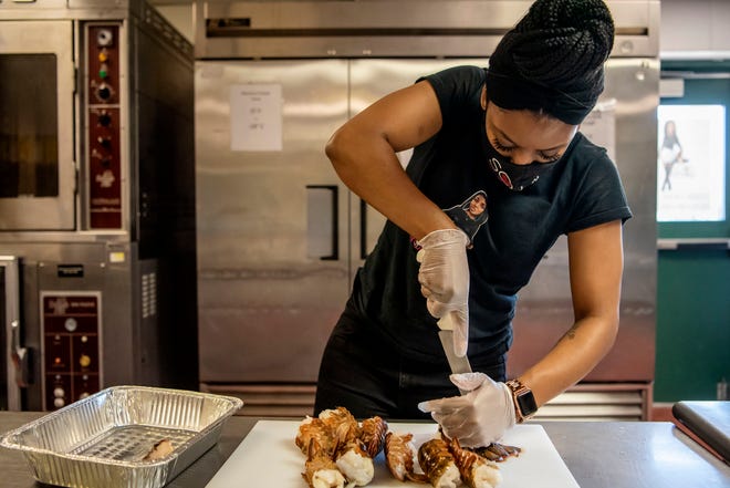 Soul Good LLC Owner Deja Wilson prepares lobster tails on Saturday, May 8, 2021 in Springfield, Mich. Wilson and a number of other local food providers will be serving dishes at Kellogg Community College's Soul Food Luncheon Feb. 22.