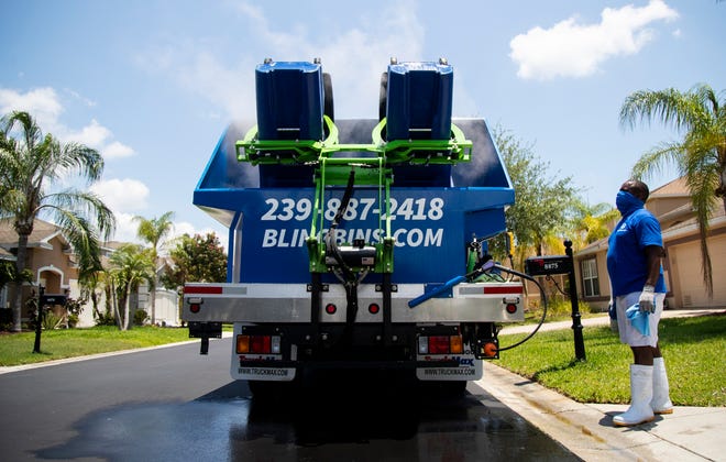 Rod Gadson watches as his truck cleans out recycle bins for his clients in a south Fort Myers neighborhood on Thursday, May 6, 2021. Gadson bought his truck from the west coast and is the only service of its kind in southwest Florida.