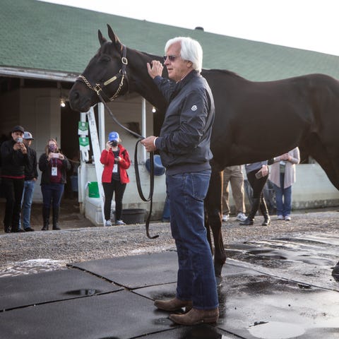 Trainer Bob Baffert holds Medina Spirit the mornin