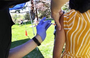 A student receives a shot during the VAX the Pack COVID-19 vaccination clinic at Whitaker Park near the University of Nevada, Reno on May 8, 2021.