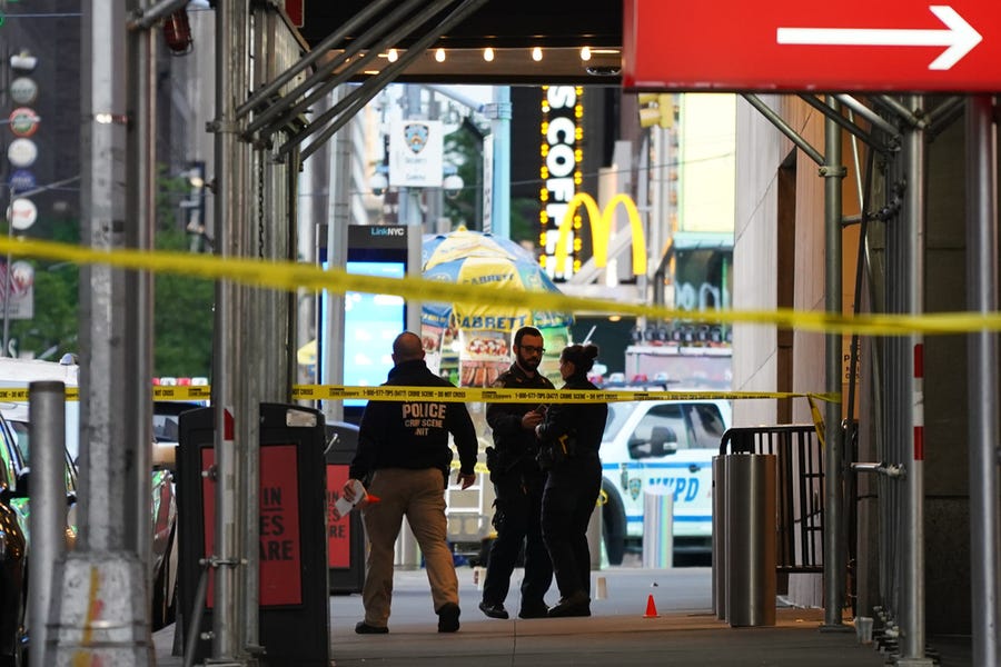 Police officers investigate a shooting in Times Square on May 8 in New York City.