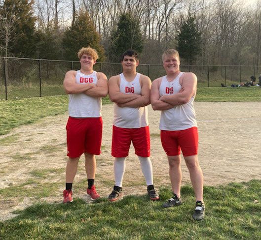 Carter Boley, Blake Willey and Grant Waymire pose for a photo after throwing personal bests in the shot put during a meet earlier this season.