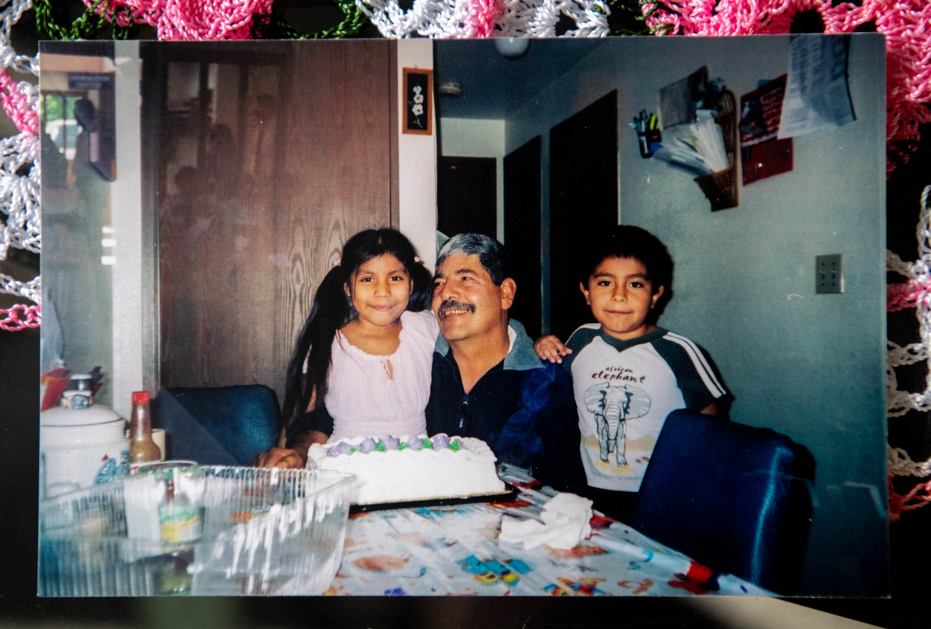 A photograph of Felipe Gutierrez, center, along with his daughter Guillermina, 6, and son José, 7, during a 2006 birthday party.