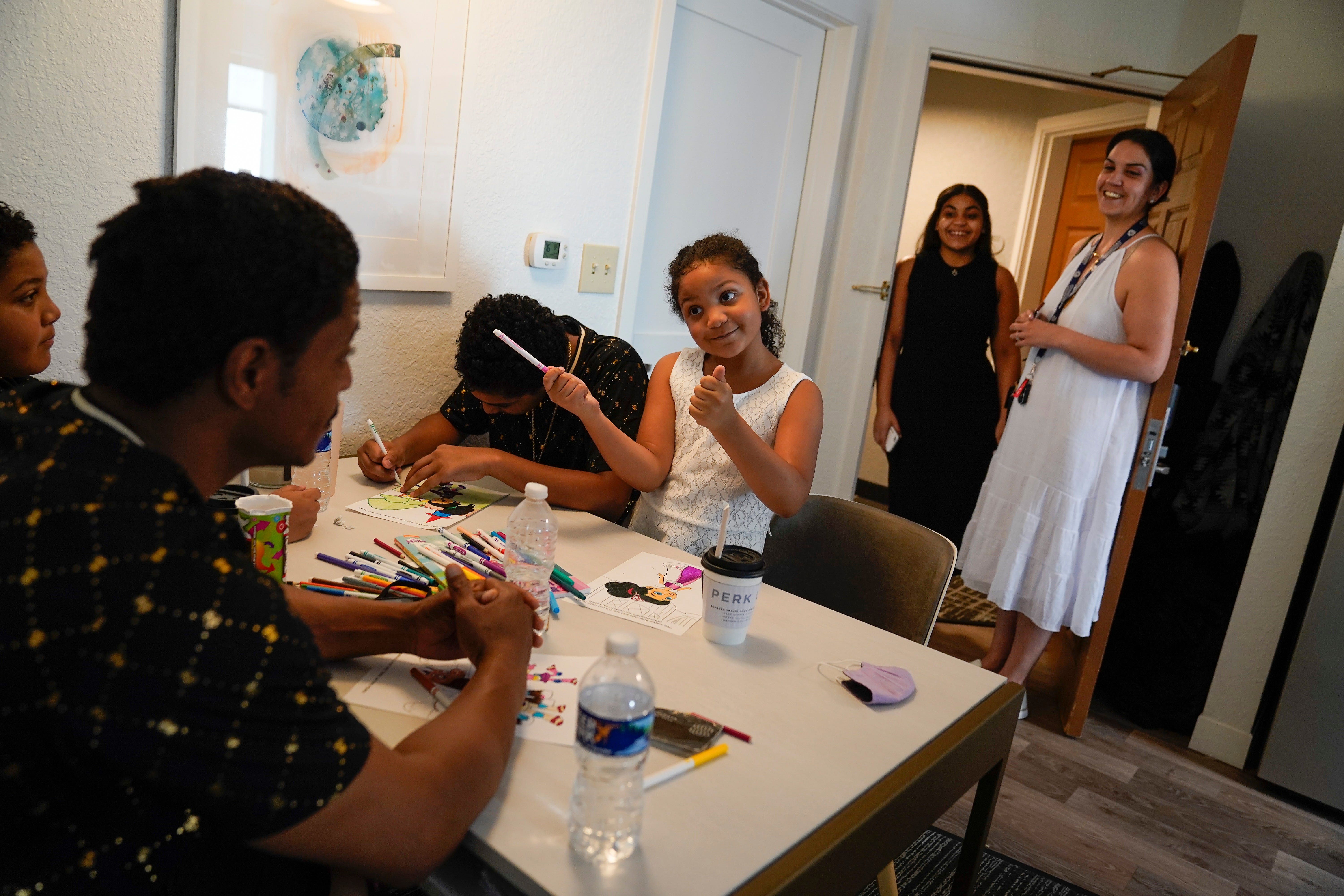 Kendrick and Michelle Harrison relocated to Northern Virginia with their children Sierra, 18, in the doorway, Alex, 14, Julius, 13, left, and Aiyanna, 8, center. The family sought a new start after a financial loss suffered in the closure of a for-profit college in Nevada. Living in extended-stay housing in Falls Church, Va., the family is looking for a home to rent or own.