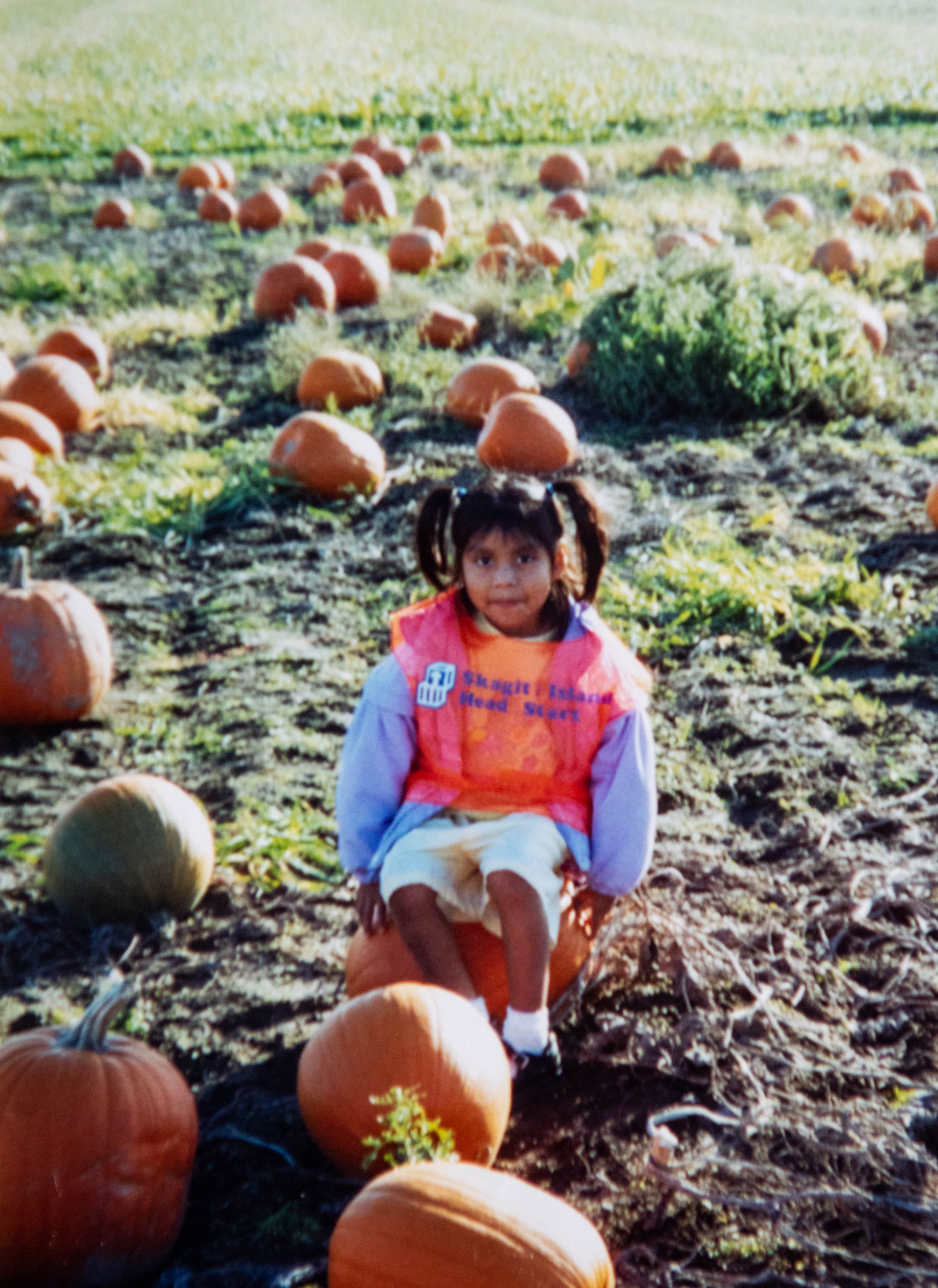 Guillermina Gutierrez Martinez, 6, sits in a field of pumpkins while attending the Skagit/Islands Head Start Program in 2006.