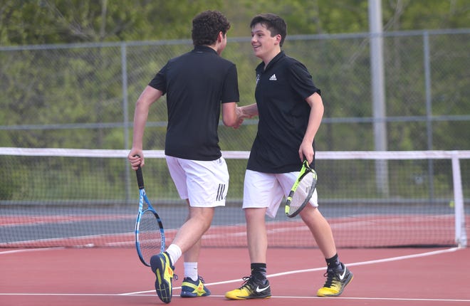 Quaker Valley's Jack Bresch (left) and Justin Hajdukiewicz (right) high-five after winning a set against the South Park Eagles during the WPIAL Class 2A Team Championship Wednesday evening at North Allegheny High School.