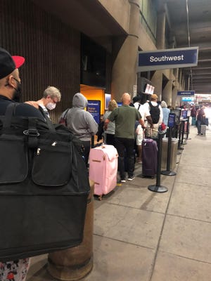 Southwest Airlines passengers in line for curbside check-in at Phoenix Sky Harbor International Airport in May.