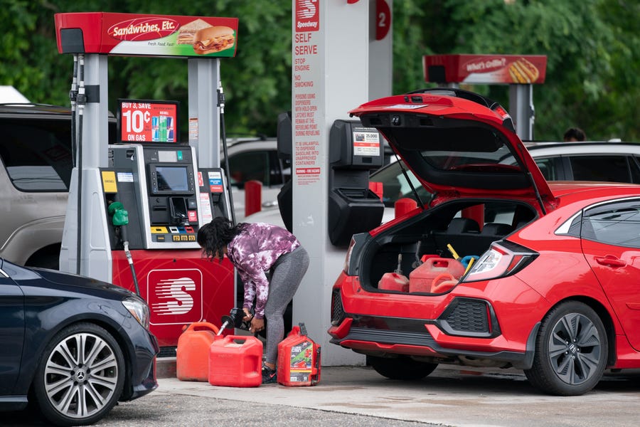 A woman fills gas cans at a Speedway gas station on May 12 in Benson, N.C. Most stations in the area along I-95 are without fuel after the Colonial Pipeline hack.