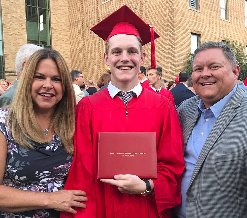 Collin and his parents, Kathleen and Wade, pose during a proud moment at his high school graduation at St. Charles Preparatory High School in June 2018.
