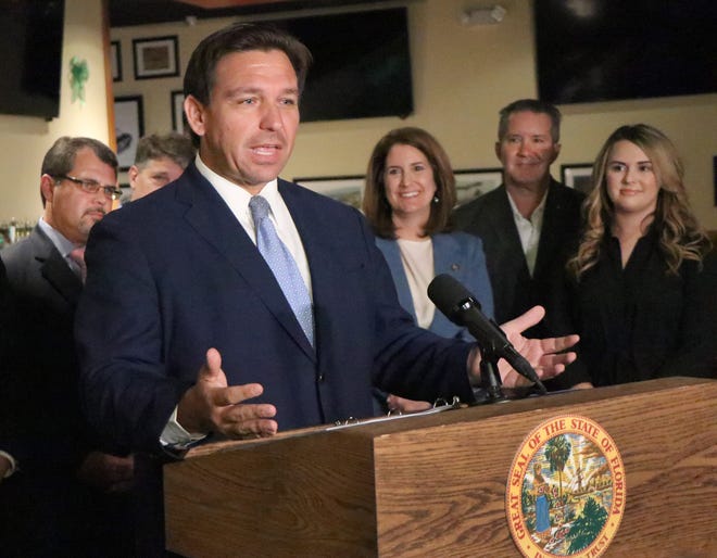 Florida Governor Ron DeSantis speaks to reporters during a press conference at Houligans in Ormond Beach, Thursday, May 13, 2021, before signing SB-148 that makes alcoholic drinks to go permanent for restaurants and some bars.