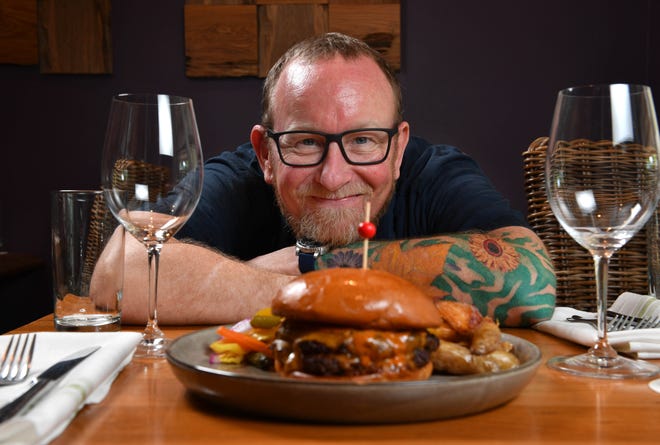 Owner and chef Steve Phelps serves My Uncle’s Burger at Indigenous in Sarasota.