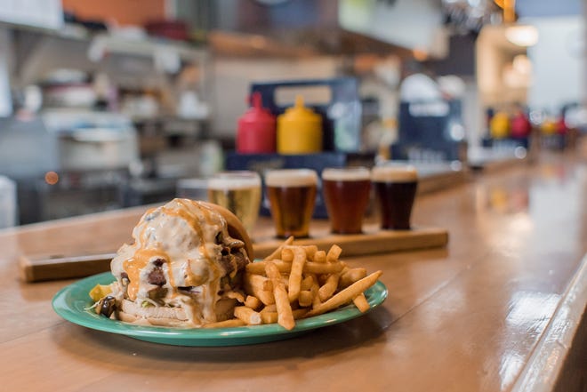 BrewBurgers in Venice serves numerous signature burgers including the “Ollie G.”