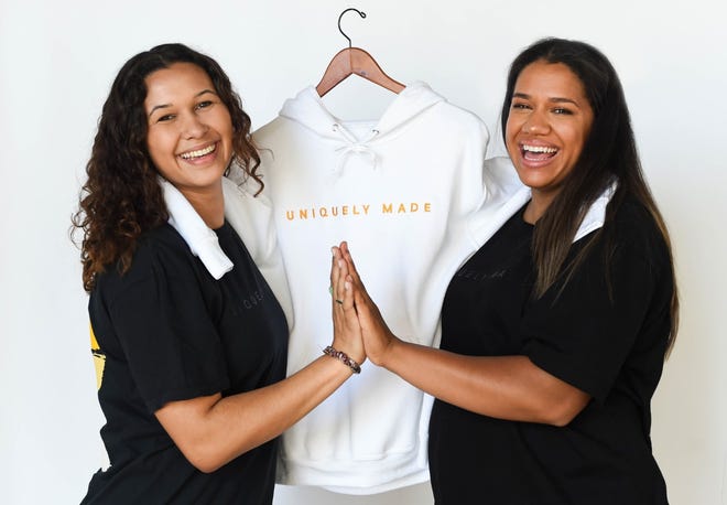 Mariah Riddlesprigger, right, owner of the Sincerely, Mariah apparel brand, poses with the brand's graphic designer, Cassidy Blanchard, left.