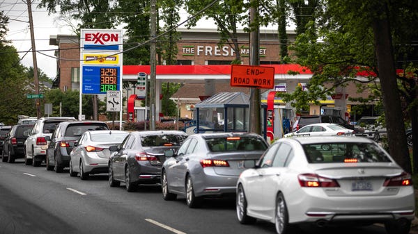 Motorists line up at an Exxon station selling gas 