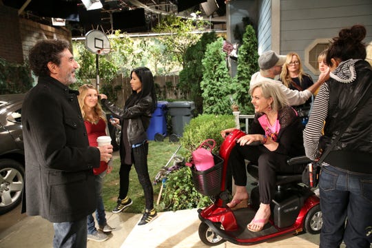 "Mom" executive producer Chuck Lorre, left, talks to star Allison Janney, sitting, during a break in the filming of a Season 1 episode of the critically acclaimed CBS sitcom.