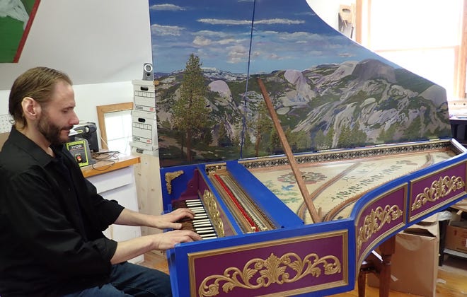 Paul Daher is seen in his home workshop in Green on May 12, 2021, playing the harpsichord he built over the past year. A new harpsichord costs from $10,000 upward.
