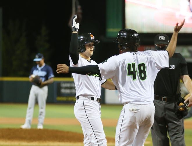 Eugene's Will Wilson, center, celebrates his eight- inning home run with Frank Labour in a game earlier this season at PK Park.