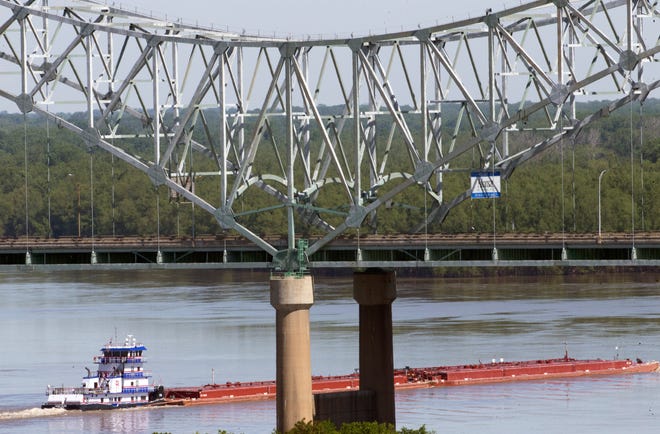 A barge passes under the Hernando de Soto bridge Friday morning, May 14, 2021, as traffic on the river was reopened for the first time since a crack was discovered on the I-40 span Tuesday, shutting down traffic on the road and the water underneath.