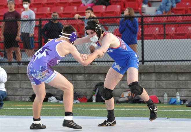 Quincy/North Quincy's Jonathan Bina, right, takes on Boston Latin opponent Eric Power during high school wrestling at Veterans Stadium in Quincy, Friday, May 14, 2021.