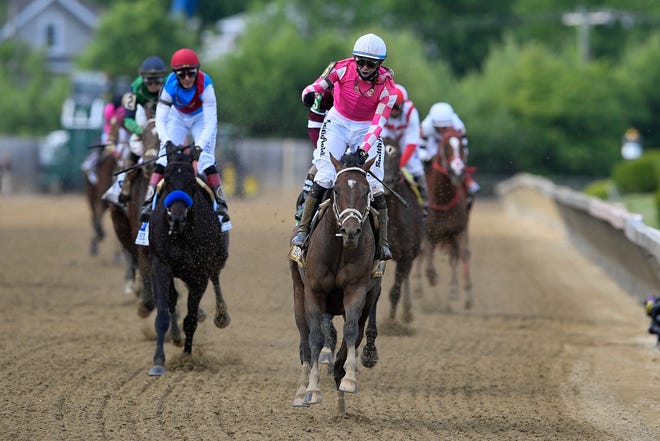 Flavien Prat atop Rombauer, center, reacts after winning the Preakness Stakes horse race at Pimlico Race Course, Saturday, May 15, 2021, in Baltimore. (AP Photo/Nick Wass)