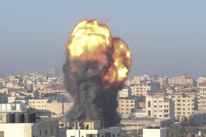 A fireball and smoke billow up into the air during an Israeli airstrike on Gaza City early on Saturday, May 15, 2021. The strike targeted the Ansar compound, which is linked to the Hamas movement in the Gaza Strip.