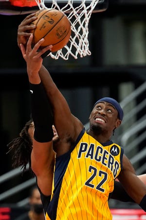 Indiana Pacers guard Caris LeVert (22) grabs a rebound away from Toronto Raptors forward Freddie Gillespie (55) during the first half of an NBA basketball game Sunday, May 16, 2021, in Tampa, Fla.
