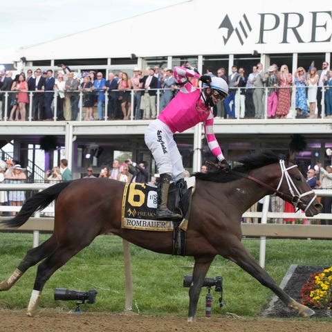 Jockey Flavien Prat celebrates as Rombauer wins th