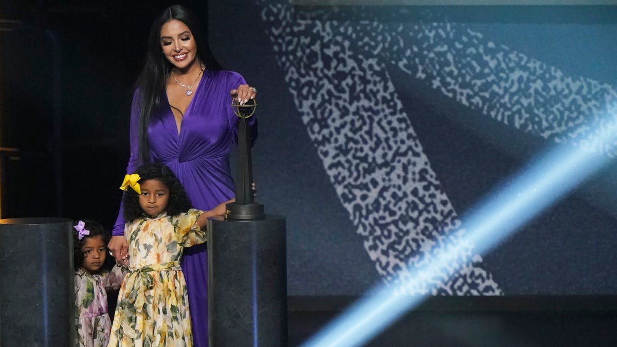 Vanessa Bryant on stage with daughters Capri and Bianka after speaking during Kobe Bryant's enshrinement.