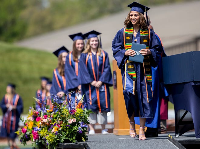 Hope College students celebrate their commencement ceremony at the Ray and Sue Smith Stadium Sunday afternoon.