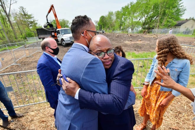 John Louis Barrow, left, hugs his brother, Joe Louis Barrow II, while looking out Monday over what will become a Detroit greenway named after their father, Joe Louis. The greenway will span more than 27 miles and connect Dearborn, Hamtramck and Highland Park.