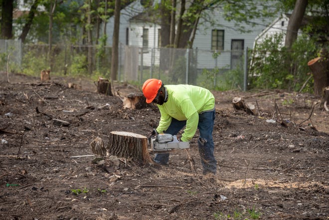 Workers begin to clear a section of the Joe Louis Greenway, in Detroit, May 17, 2021.  The Greenway will span 27 miles through the city, connecting with Dearborn, Hamtramck, and Highland Park.