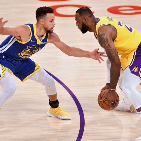 LeBron James goes up against Steph Curry during a 