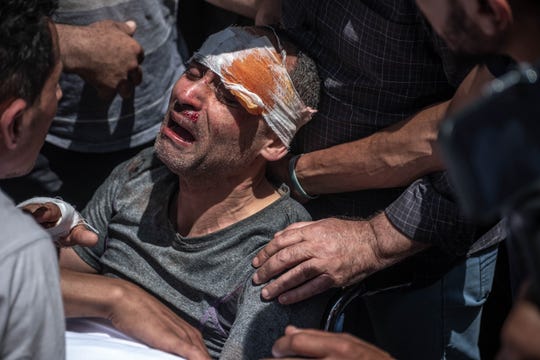 A Palestinian survivor mourns his children who were killed in a violent Israeli raid in the central Gaza Strip on May 16, 2021 in Gaza City, Gaza.
