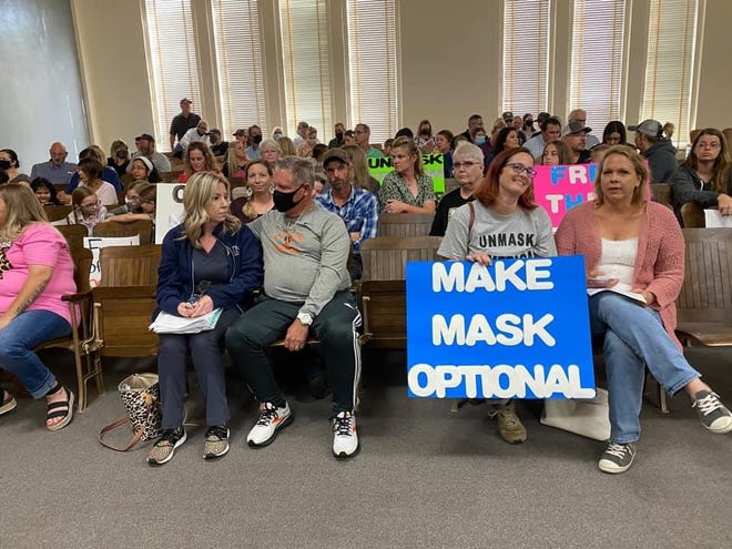 Parents and residents for and against the Smithville school district's mask requirement are seated during Monday night's school board meeting. The board voted 6-1 to revoke the school district's face covering requirement for students, teachers and staff members.