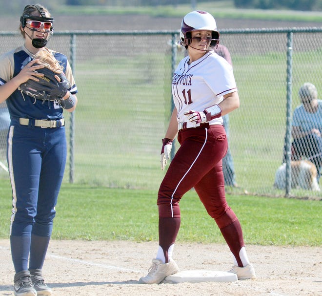 Charlevoix senior Avery Zipp (right) watches a teammate in the batter's box before taking a lead at first base.