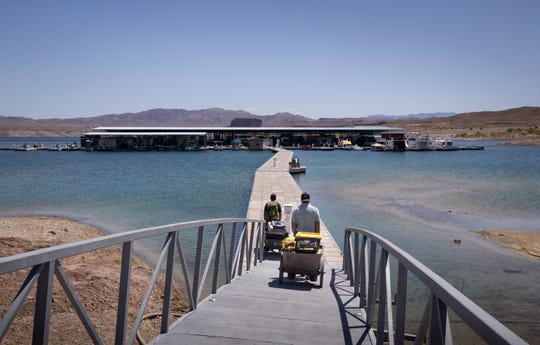 Barbaros Demircar (right) and Mike Darin haul gear down to their boat at Temple Bar Marina on May 10, 2021, in the Lake Mead National Recreation Area, Arizona.