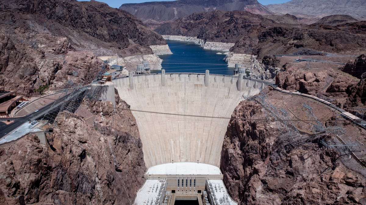 A high-water mark or "bathtub ring" is visible on the shoreline of Lake Mead at Hoover Dam.