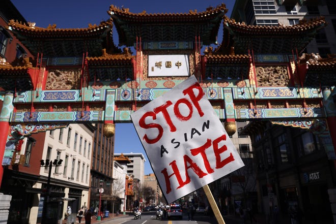 An activist holds a sign after he marched to Chinatown from a “DC Rally for Collective Safety - Protect Asian/AAPI Communities,” hosted by OCA – Asian Pacific American Advocates, at McPherson Square March 21, 2021, in Washington, D.C. Activists took part in the rally in response to the Atlanta, Georgia spa shootings that left eight people dead, including six Asian women, and the rising number of attacks against Asian Americans and Pacific Islanders since the COVID-19 pandemic began in 2020.