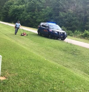 Georgia State Patrol Cpl. Neil Frankel cuts grass for an elderly Oglethorpe County man who had fallen while cutting his lawn.