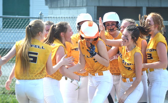 Pellston players celebrate with teammate Madison Brown at home plate after Brown hit a solo home run during game one of a Ski Valley softball doubleheader against Onaway in Tower on Tuesday.