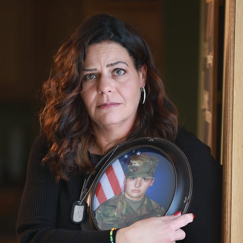 Carey Harris holds an Army photograph of her daugh