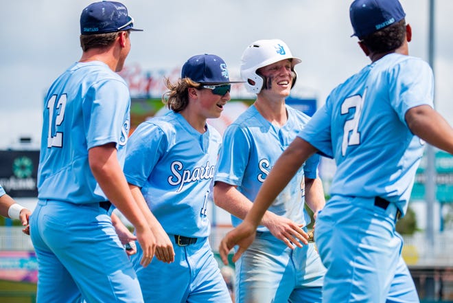 St. Johns Country Day players congratulate Connor Moore (third from left) after his two-run home run against Mount Dora Christian in Wednesday's FHSAA Class 2A baseball semifinal.